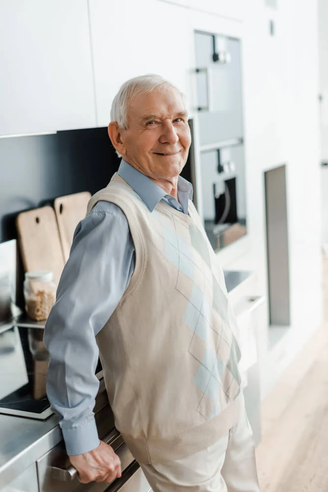 A man in his independent senior living apartment