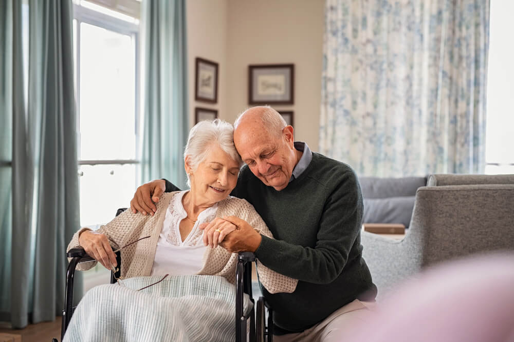 a couple embraces in a memory care facility in crosslake, mn