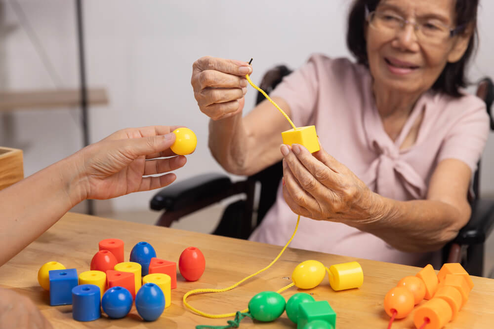 A woman plays memory games while in memory care near Nisswa, MN at Whitefish at the Lakes.